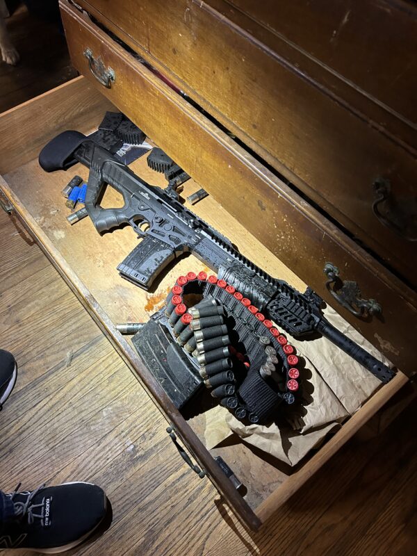 Photo of 12 Gauge Semi-Auto Shotgun found on defendant's premises.