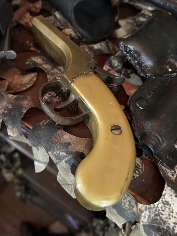 Photo of Frame of Derringer Double Barrel Pistol found on defendant's premises.